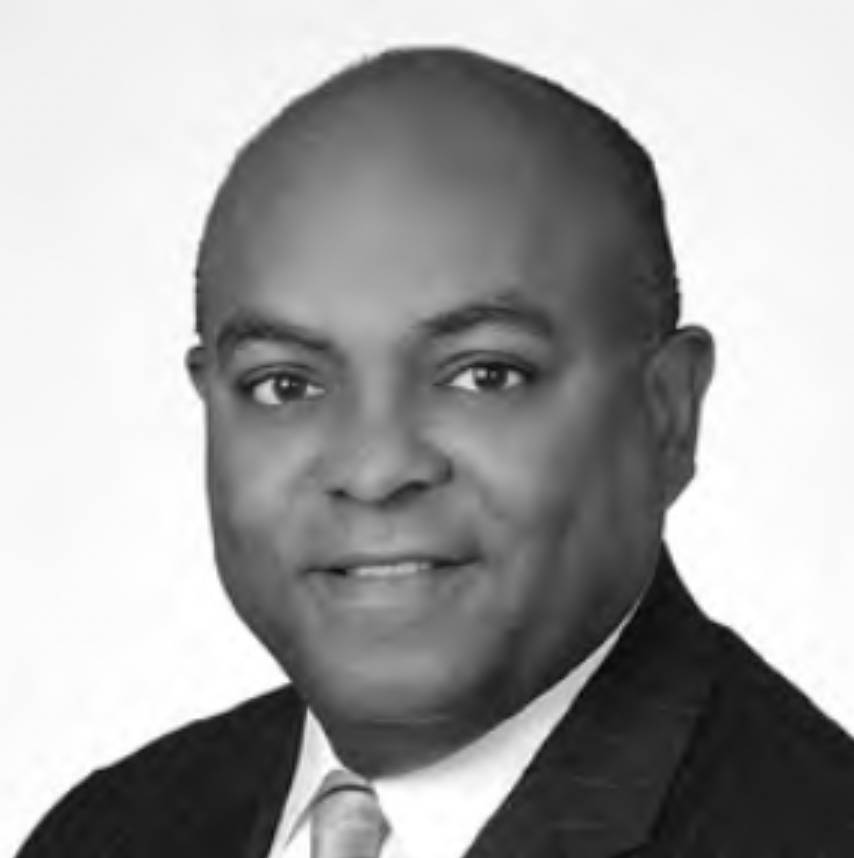 Headshot of Tyree P. Jones, Jr., a man in suit smiling at camera against white background